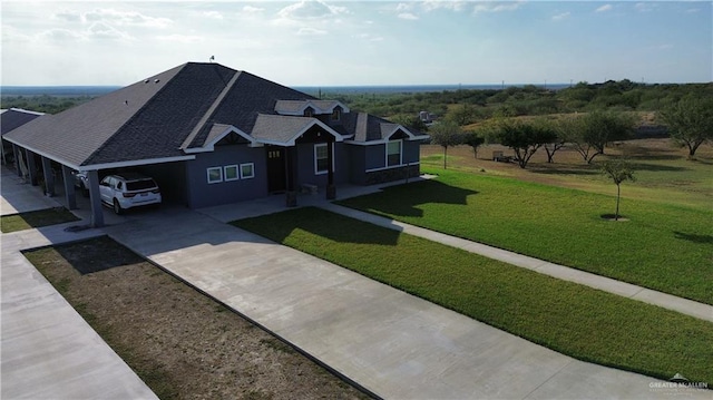 view of front of home with a garage and a front lawn