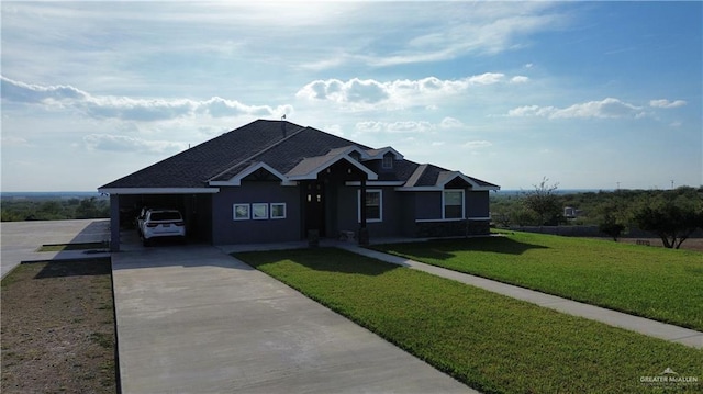 view of front of home with a front yard and a carport