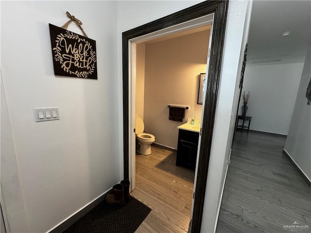 corridor with hardwood / wood-style flooring