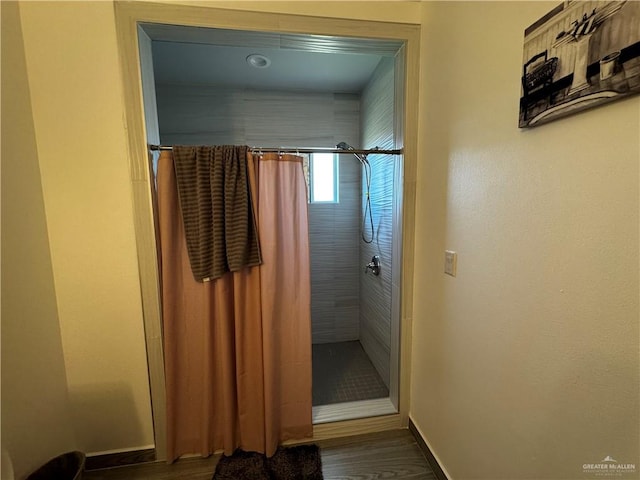 bathroom with hardwood / wood-style floors and a shower with shower curtain