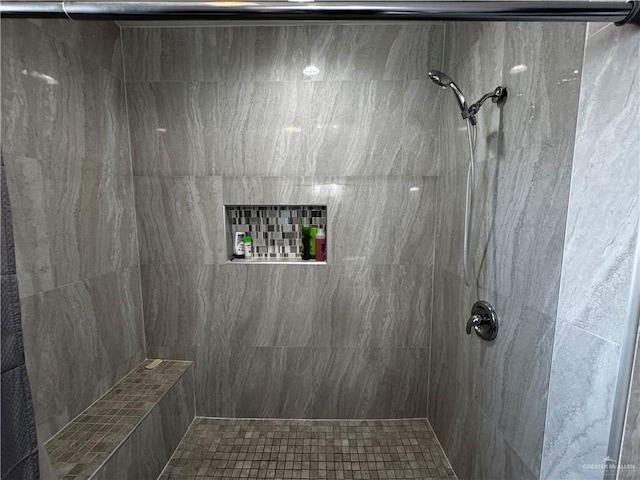 bathroom with tiled shower