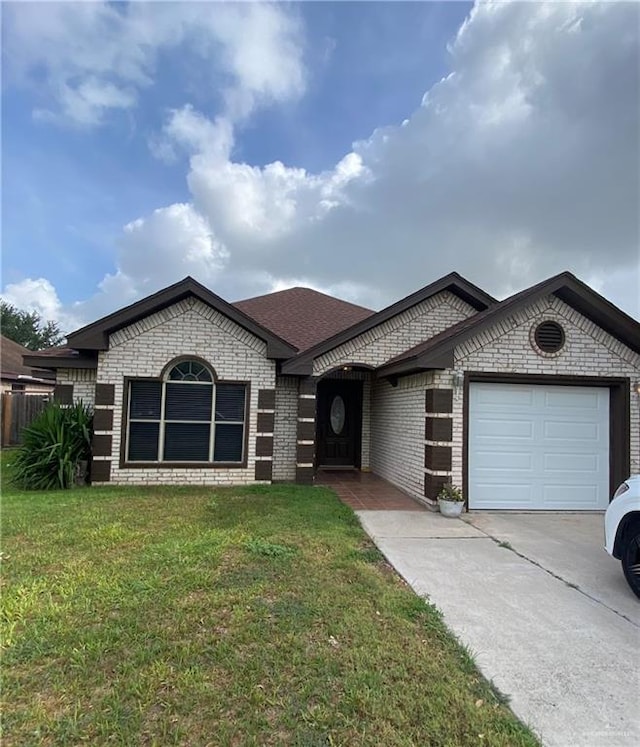 1903 E Llano Grande St, Weslaco, TX 78596 - french country inspired facade with an attached garage, concrete driveway, brick siding, and a shingled roof