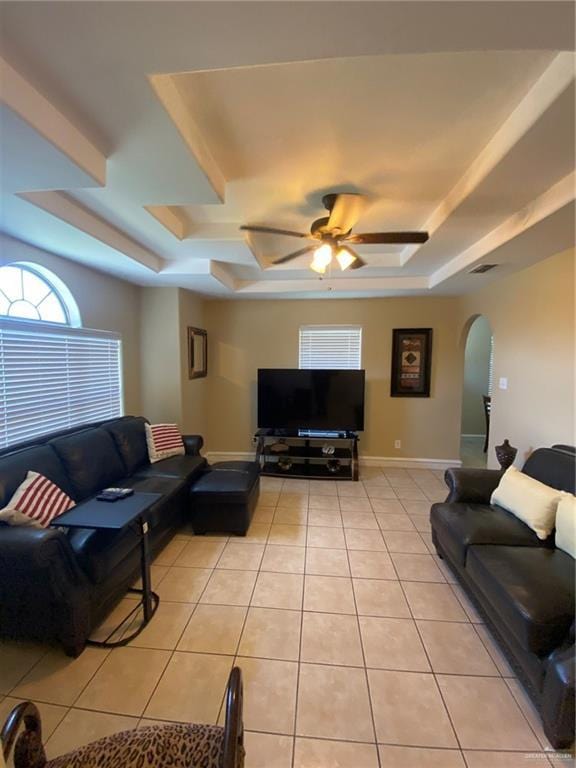 1903 E Llano Grande St, Weslaco, TX 78596 - living area with a tray ceiling, arched walkways, light tile patterned floors, and ceiling fan