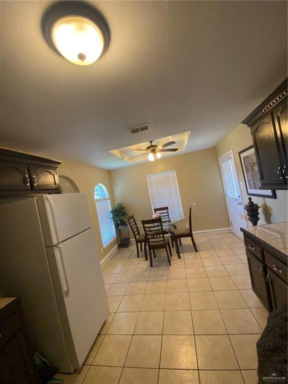 1903 E Llano Grande St, Weslaco, TX 78596 - dining space featuring light tile patterned flooring, a ceiling fan, and baseboards