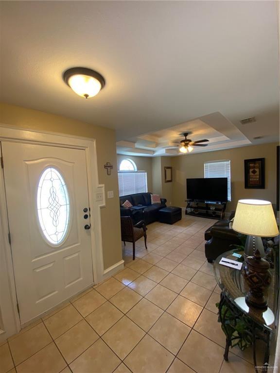 1903 E Llano Grande St, Weslaco, TX 78596 - foyer with a tray ceiling, light tile patterned floors, and ceiling fan