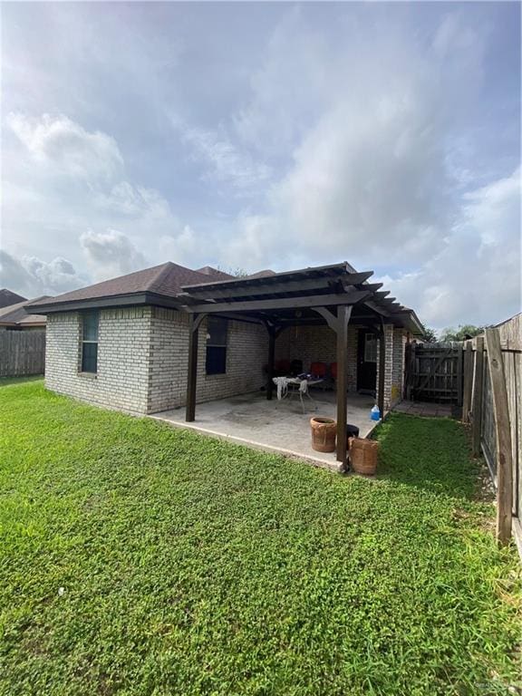 1903 E Llano Grande St, Weslaco, TX 78596 - rear view of house with a pergola, brick siding, and a patio