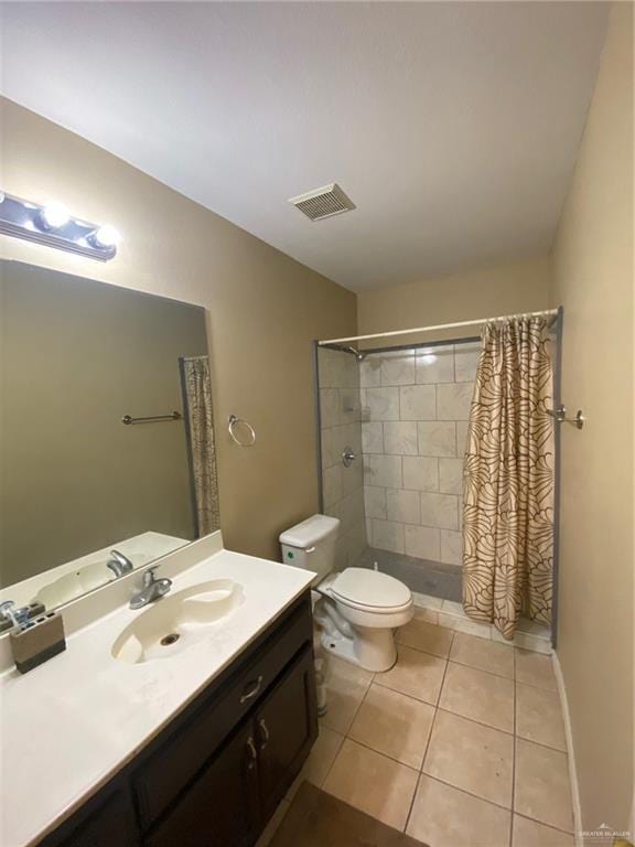 1903 E Llano Grande St, Weslaco, TX 78596 - bathroom with vanity, tile patterned flooring, toilet, and a tile shower
