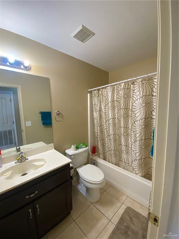 1903 E Llano Grande St, Weslaco, TX 78596 - bathroom featuring vanity, toilet, shower / bath combo, and tile patterned floors