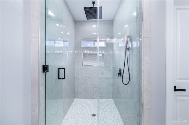 bathroom with a shower with door