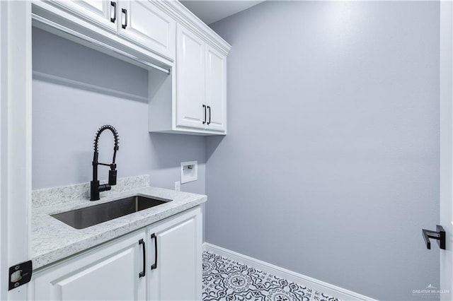 washroom with cabinets, sink, and washer hookup