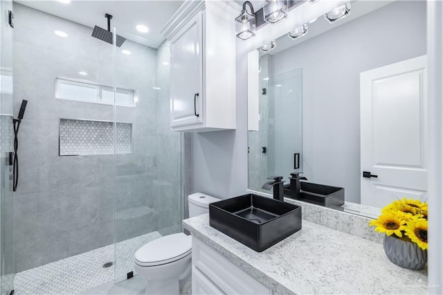 bathroom with an enclosed shower, vanity, and toilet