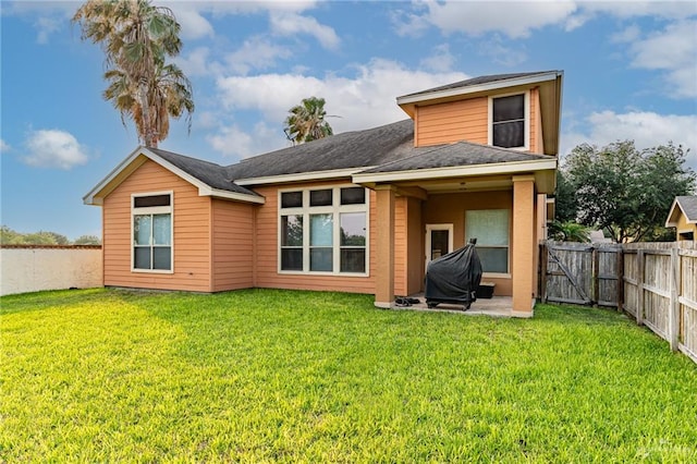 rear view of property featuring a lawn