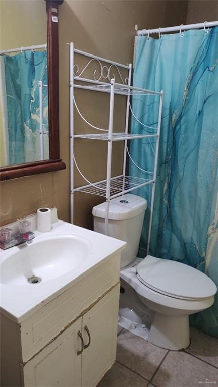 bathroom featuring tile patterned flooring, vanity, toilet, and curtained shower