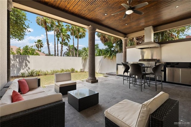 101 San Jacinto St, Mission, TX 78572 - fenced backyard with outdoor lounge area, a patio, an outdoor kitchen, a bar, and a ceiling fan