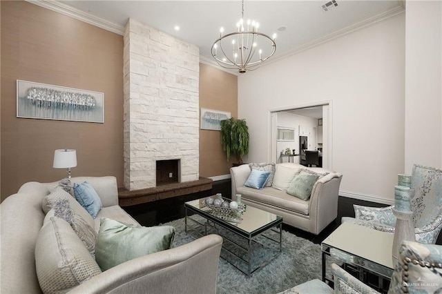 101 San Jacinto St, Mission, TX 78572 - living area with a chandelier, ornamental molding, a stone fireplace, and wood finished floors