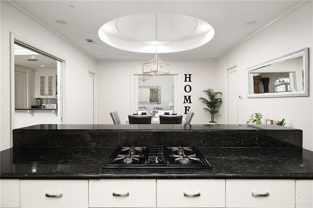 101 San Jacinto St, Mission, TX 78572 - kitchen with gas stovetop, white cabinets, a raised ceiling, dark stone countertops, and decorative light fixtures
