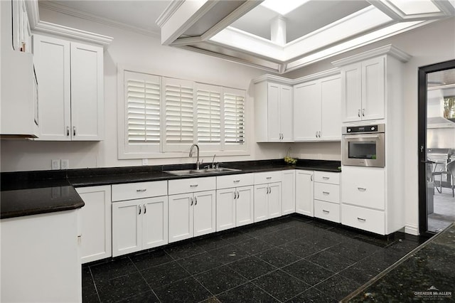 101 San Jacinto St, Mission, TX 78572 - kitchen with oven, granite floors, white cabinets, and crown molding