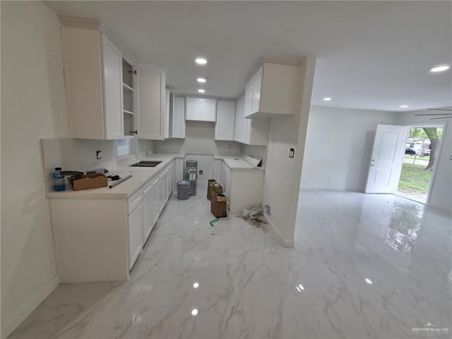 kitchen featuring baseboards, recessed lighting, white cabinetry, and marble finish floor