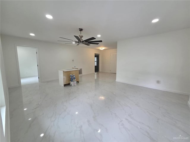 empty room featuring recessed lighting, a ceiling fan, and baseboards