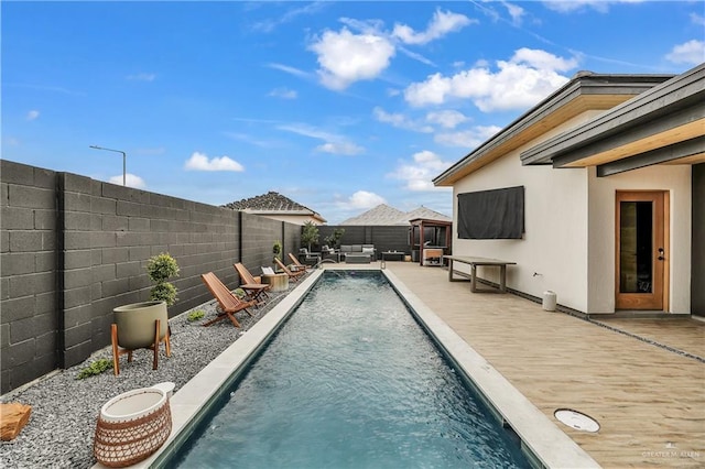 view of pool featuring pool water feature, an outdoor hangout area, and a patio area