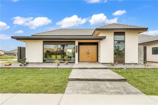 entrance to property with a lawn