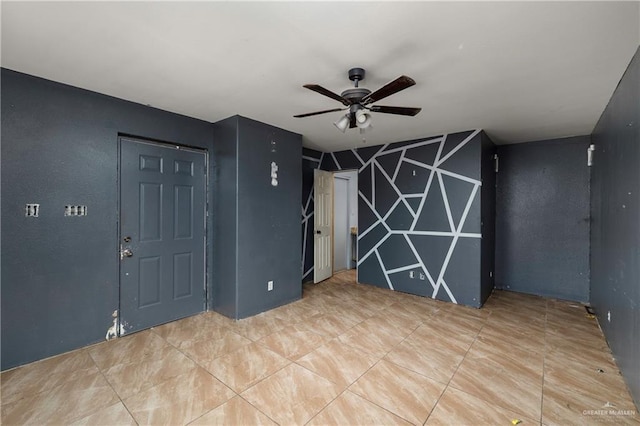 spare room featuring a ceiling fan