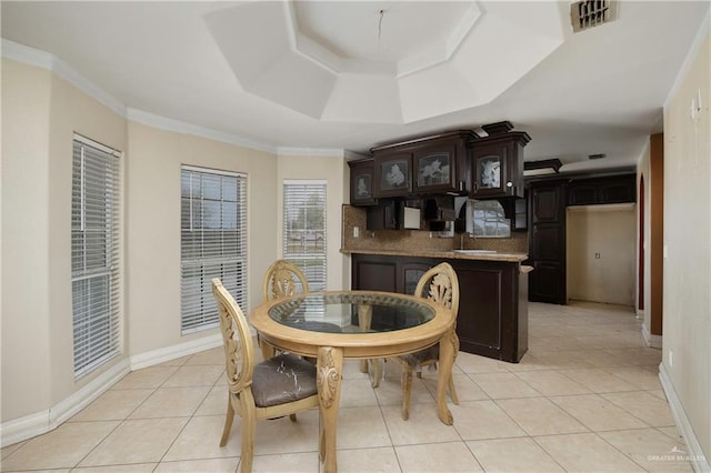 dining room with ornamental molding, visible vents, baseboards, and light tile patterned flooring