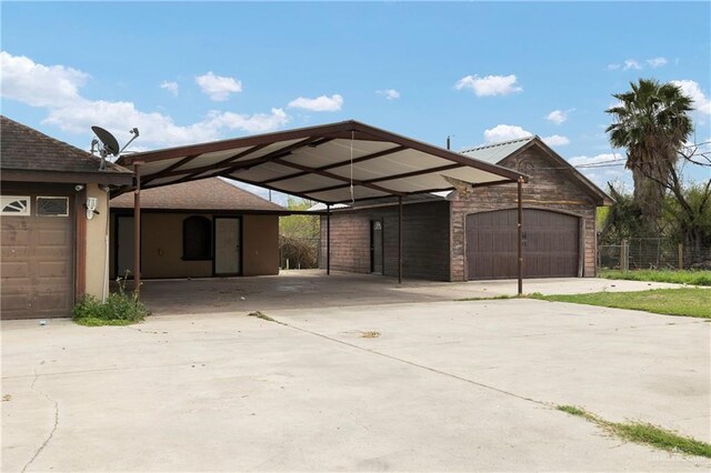 view of front of house with a carport, driveway, and fence