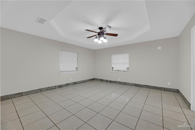 1619 Beech Ave, Mercedes, TX 78570 - unfurnished room featuring a tray ceiling, a ceiling fan, light tile patterned floors, and baseboards