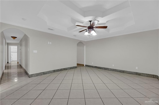 1619 Beech Ave, Mercedes, TX 78570 - unfurnished room featuring a raised ceiling, a ceiling fan, arched walkways, light tile patterned floors, and baseboards