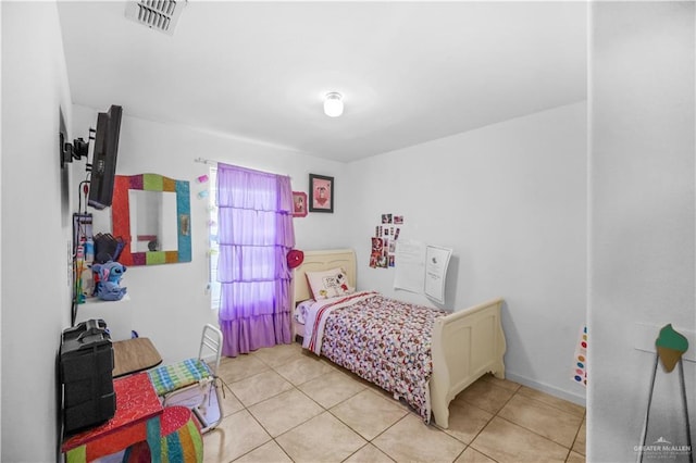 bedroom featuring light tile patterned floors and visible vents