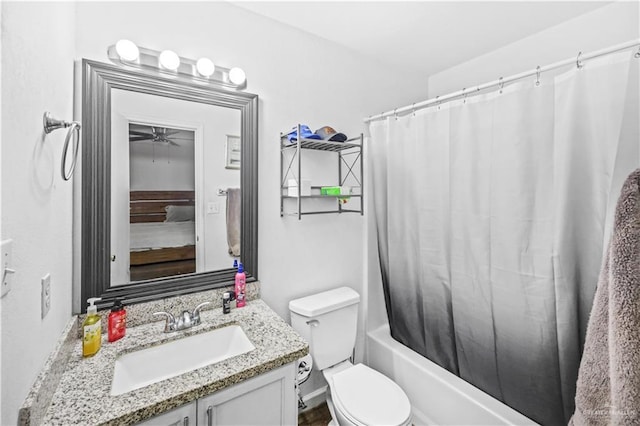 bathroom featuring vanity, toilet, a ceiling fan, and shower / bath combo