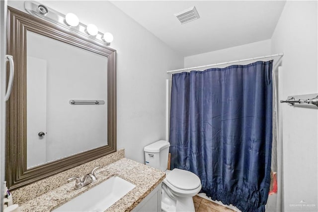 bathroom with visible vents, toilet, a shower with curtain, tile patterned flooring, and vanity