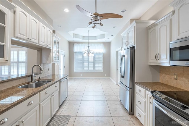 kitchen featuring appliances with stainless steel finishes, white cabinetry, plenty of natural light, and sink