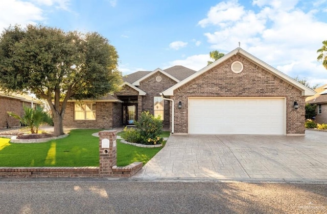 view of front of property with a garage and a front lawn