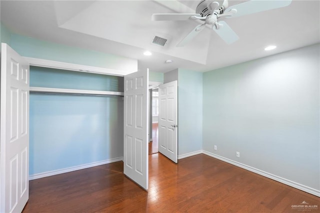 unfurnished bedroom with a closet, ceiling fan, and dark hardwood / wood-style flooring