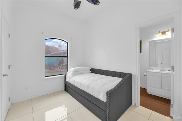 bedroom featuring connected bathroom, ceiling fan, and light hardwood / wood-style flooring