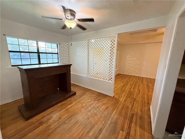 interior space with ceiling fan and wood-type flooring