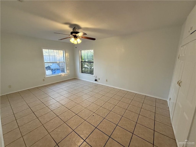 unfurnished room featuring light tile patterned floors and ceiling fan