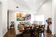 dining area featuring dark hardwood / wood-style flooring and lofted ceiling