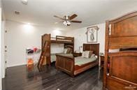 bedroom with dark hardwood / wood-style floors