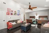 bedroom with ceiling fan, dark hardwood / wood-style floors, and vaulted ceiling