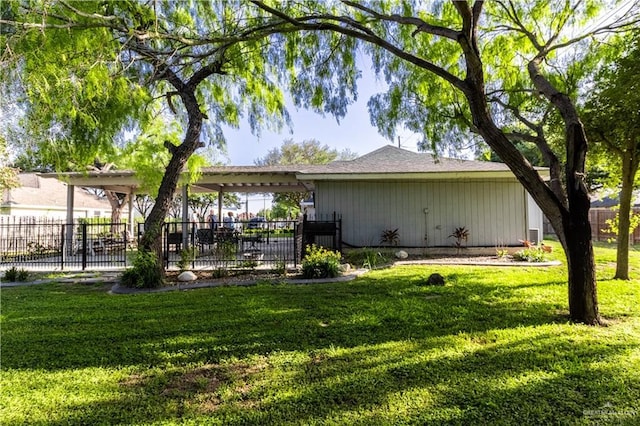 rear view of house featuring a lawn