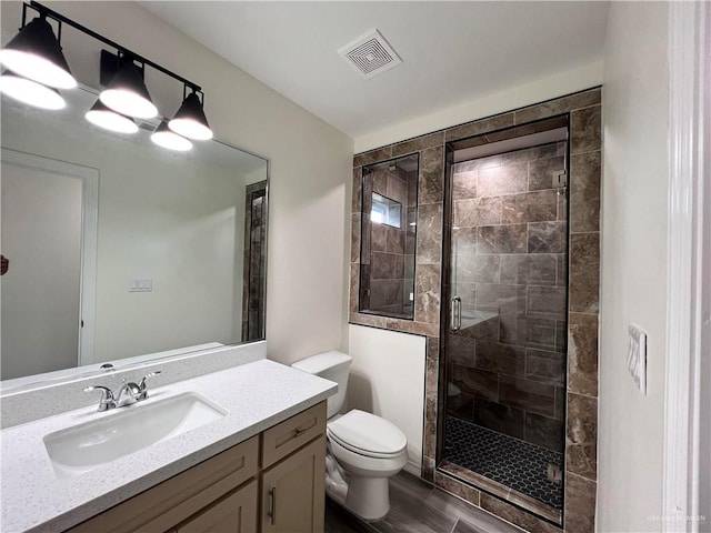 bathroom with toilet, vanity, and walk in shower