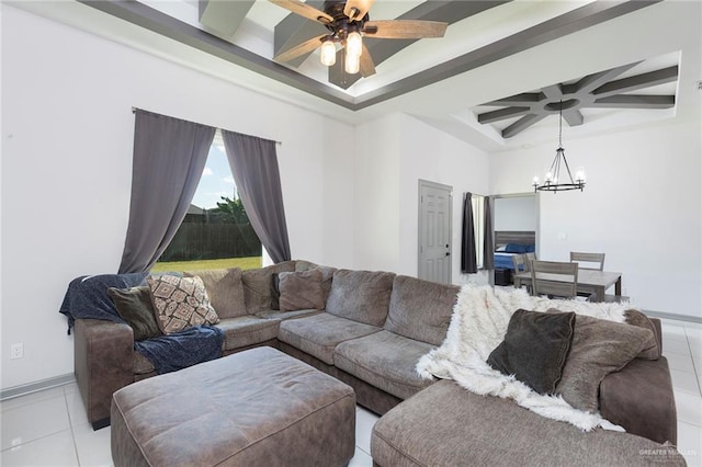 tiled living room featuring ceiling fan with notable chandelier