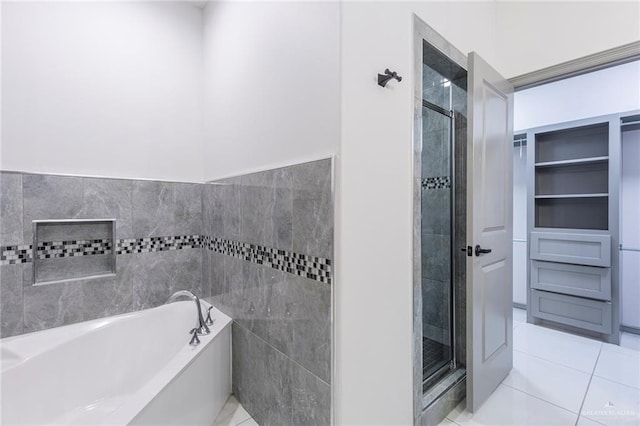 bathroom featuring tile patterned floors and independent shower and bath