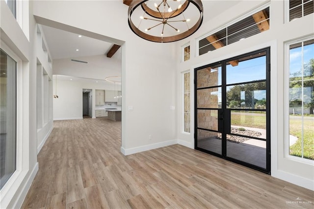 17956 Garrett Rd, Harlingen, TX 78552 - spare room with a chandelier, healthy amount of natural light, light wood-style flooring, recessed lighting, and high vaulted ceiling