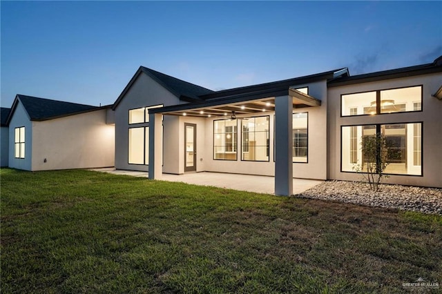 17956 Garrett Rd, Harlingen, TX 78552 - back of property with a patio, stucco siding, and a lawn