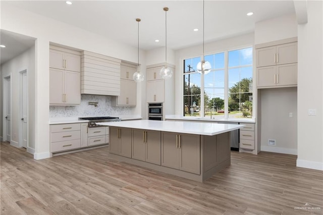 17956 Garrett Rd, Harlingen, TX 78552 - kitchen with gray cabinets, premium range hood, backsplash, appliances with stainless steel finishes, and recessed lighting