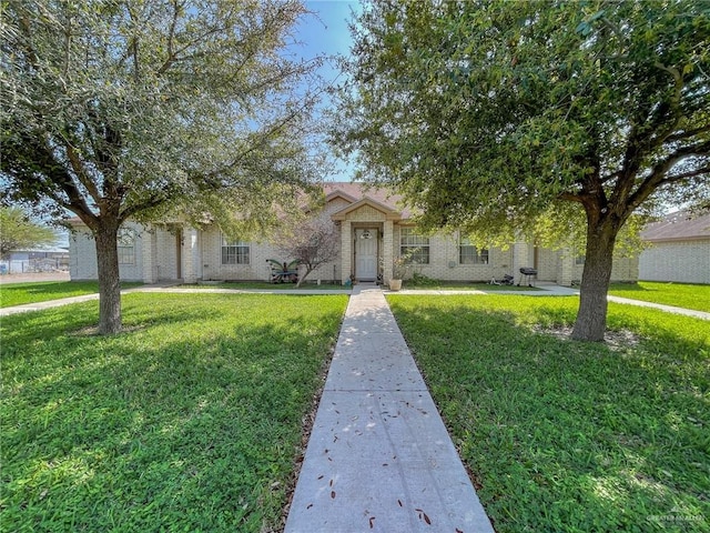 view of property hidden behind natural elements featuring a front lawn